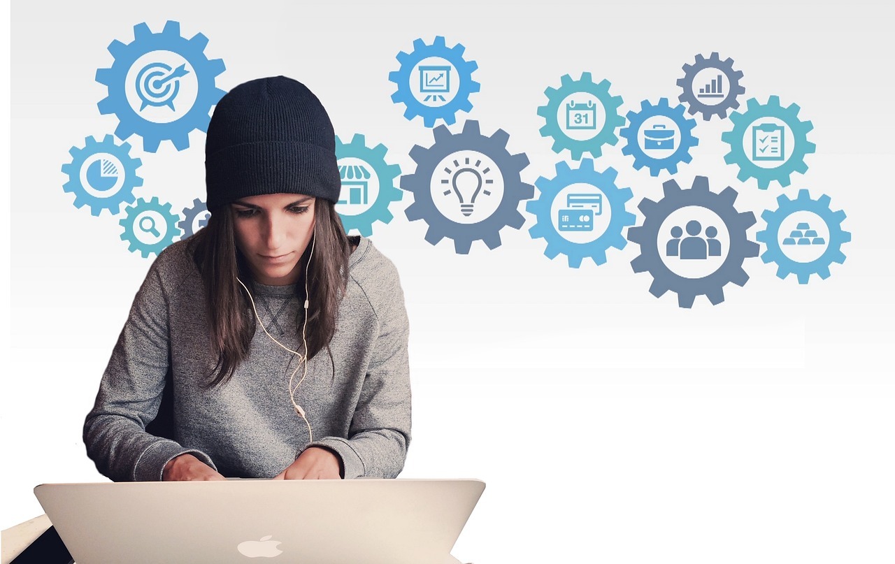 Woman working on a laptop with tech symbols behind